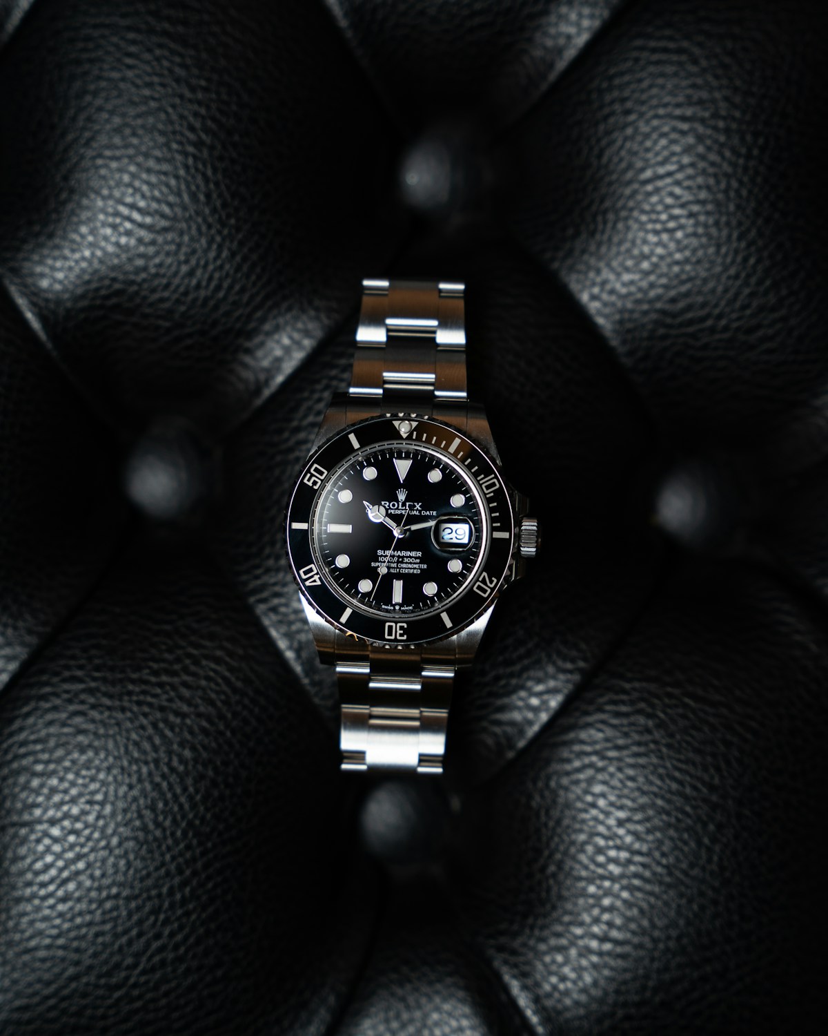 Detail of the bracelet and black dial of a luxury watch